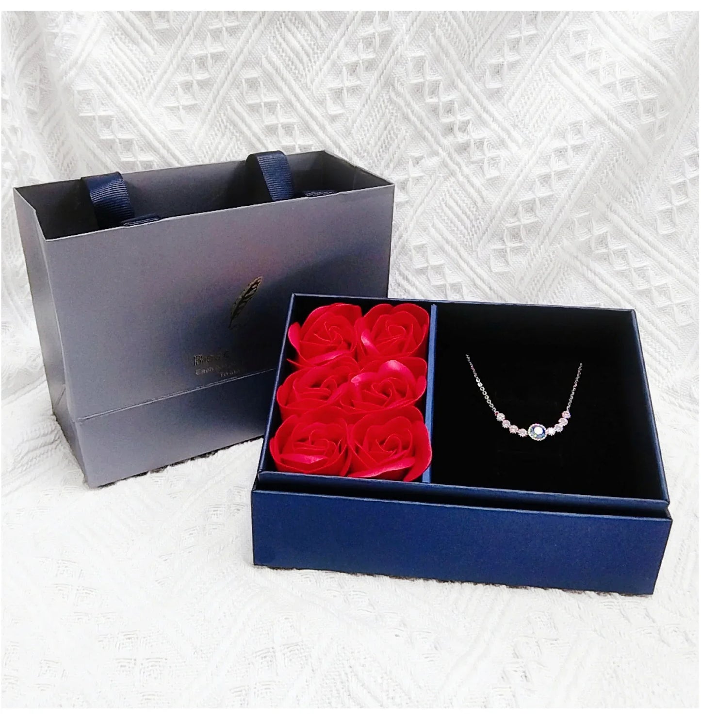 Blue preserved rose jewelry box with “Best Wishes” cover and jewelry slot to the right
