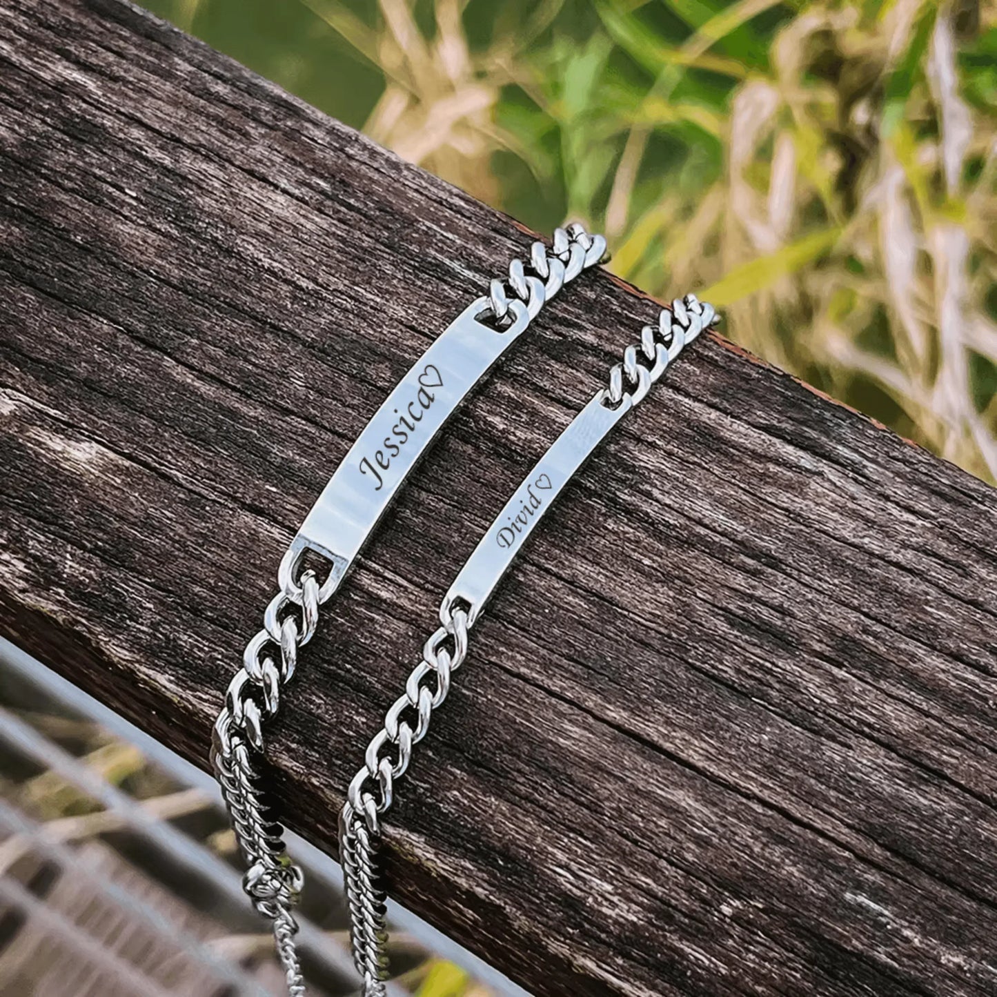 Couple name engraved bracelet set displayed in pink Eternal Rose Box with red roses and two silver ID-chain bracelets.