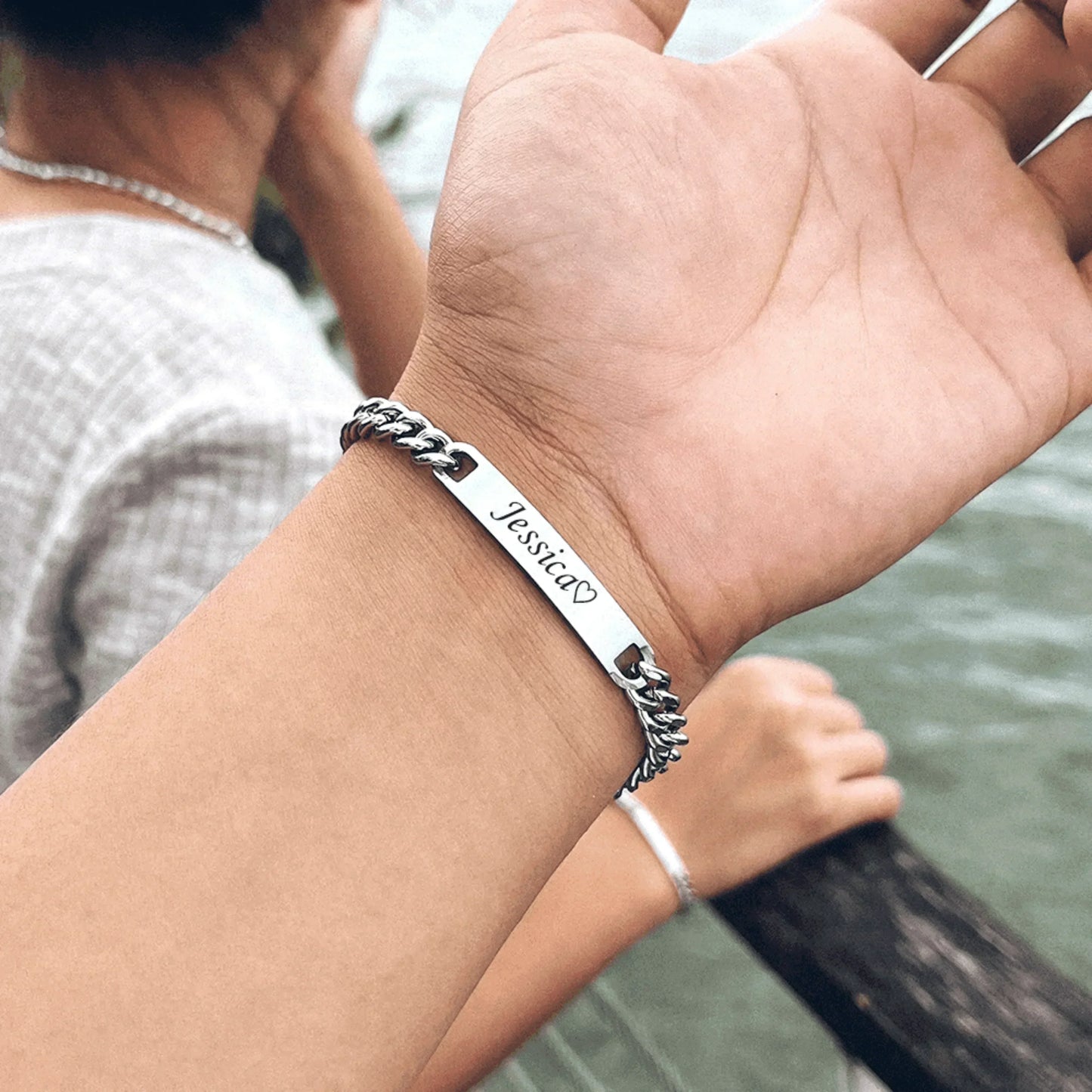 Elegant couple bracelet set with custom name engraving in silver, presented in a rose gift box.