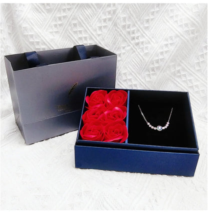 Blue preserved rose jewelry box with “Best Wishes” cover and jewelry slot to the right